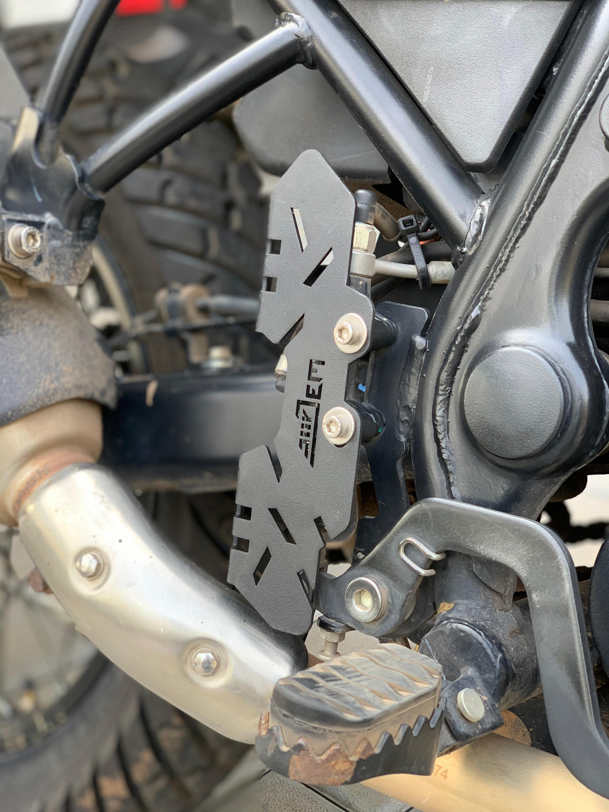 Jorjem International Himalayan Scram 411 master cylinder guard mounted on motorcycle, protective metal cover for brake system.