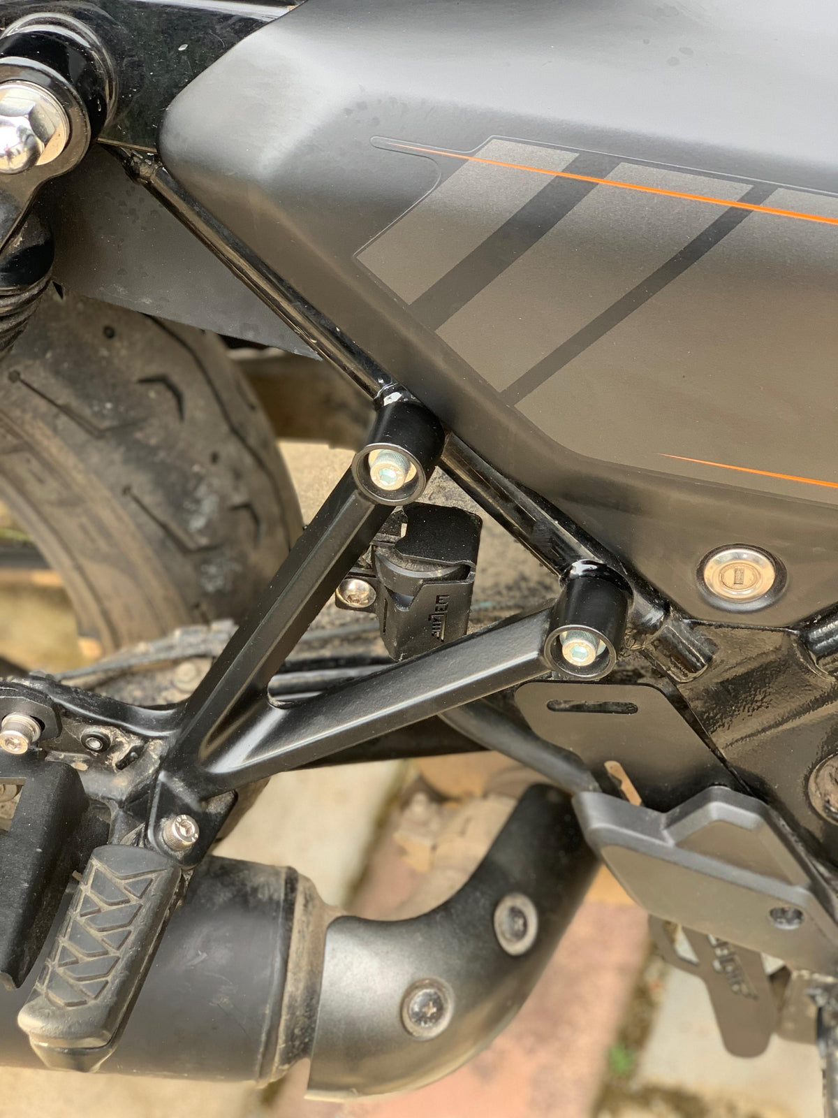 Harley X440 oil container guard by Jorjem International Pvt Ltd, protective black plastic cover for motorcycle oil tank.