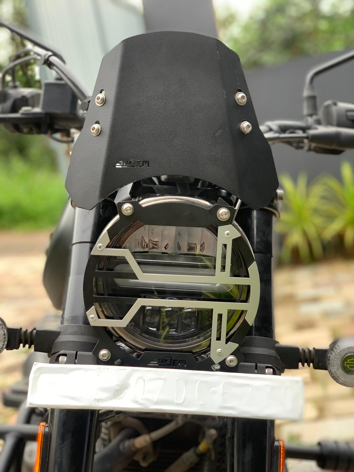 Harley X440 headlight grill by Jorjem International, showcasing a sleek metal design with protective mesh.